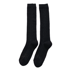 Classic black knee-high Lolita socks with diamond pattern and ribbed cuffs on white back