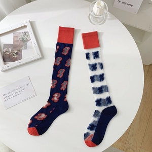 Close-up of candy-colored JK mid-calf socks with cute bear and blue butterfly patterns