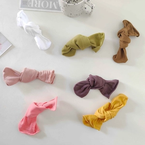 Flat lay of colorful ribbed knit bow hair clips in various candy colors on a clean surface