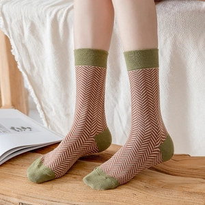 Close-up of retro herringbone cotton socks with green contrast heel and toe details
