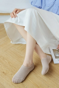 Detail of beige breathable mesh no-show socks with non-slip silicone heel for women