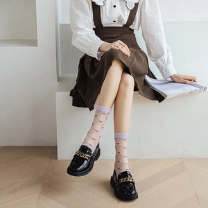 Stylish sheer purple mesh crew socks paired with black patent leather loafers with gold chain