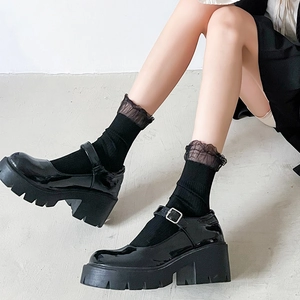 Glossy black Mary Jane platform shoes with lace crew socks in a stylish college style