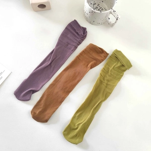 Detail view of colorful ribbed knit long socks in purple, brown and yellow hues
