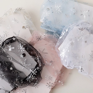 Detail of sheer mesh socks featuring silver glitter snowflake and star patterns in five colors
