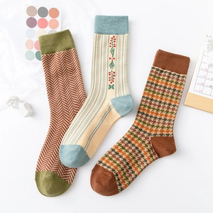 Detailed view of vintage cotton mid-tube socks with houndstooth and floral embroidery