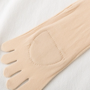 Close-up of beige five-finger socks with reinforced toe seams and breathable knit fabric