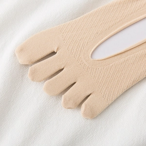 Close-up of beige five-finger hidden socks with breathable mesh texture and non-slip design