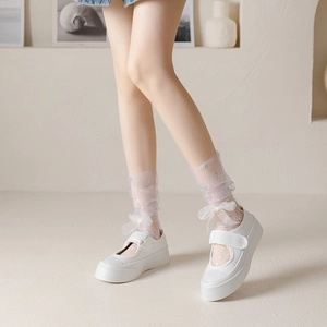 Japanese style sheer lace socks with delicate bows paired with white platform Mary Jane shoes