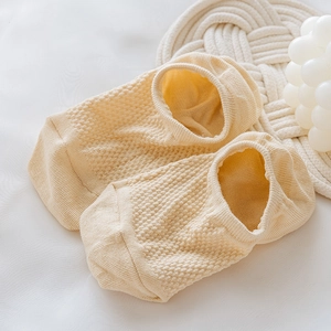 Detail of beige mesh boat socks featuring breathable waffle texture and elastic edges