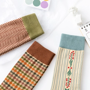 Three pairs of vintage houndstooth and floral crew socks in mid-tube cotton knit style