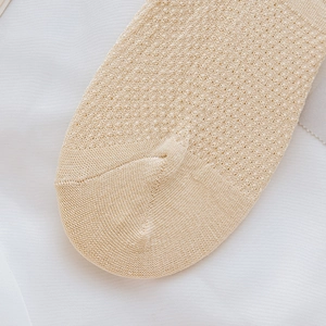 Detail of beige mesh socks showing seamless toe stitching and breathable knit texture