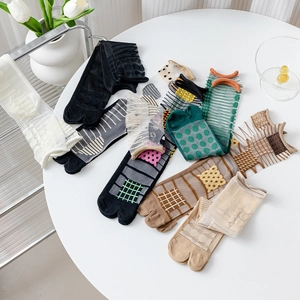 Detail of ultra-thin Tabi socks with diverse patterns including stripes and polka dots