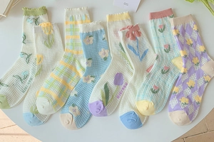 Detailed view of breathable mesh socks with tulip flower and pastel checkered patterns