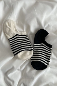 Détail de chaussettes invisibles à rayures classiques noires et blanches en coton doux