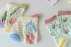 Close-up of breathable mesh socks featuring floral tulip patterns and colorful macaron toes