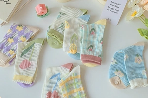 Close-up of floral mesh socks featuring tulip and plaid patterns in pastel colors