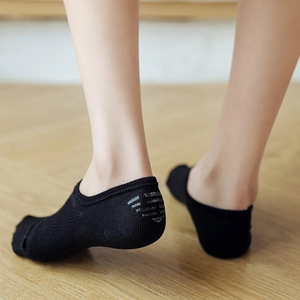 Breathable black low cut liner socks with non-slip heel grip for women on wooden floor