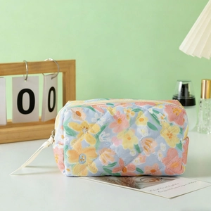Floral quilted makeup bag with vintage oil painting flowers and ribbon zipper pull
