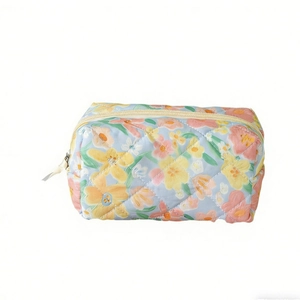Quilted floral makeup bag with blue base and yellow flower patterns for storage