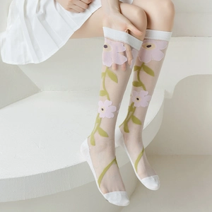 Detail of sheer white calf socks featuring floral embroidery and reinforced toe area