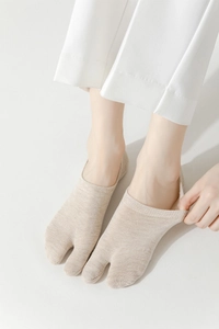 Detail of light beige tabi socks with cotton texture for split-toe shoes and low cut