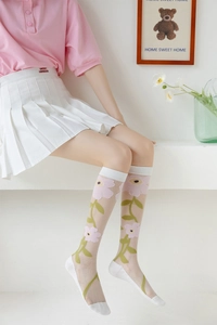 Detail of sheer mesh summer socks with pink flower embroidery and white ribbed cuffs