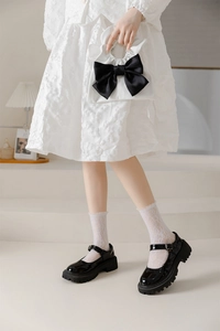Detail of white lace hollow socks paired with black platform Mary Jane shoes for JK style