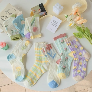 Floral pattern mesh crew socks for women in soft macaron colors like mint green and lavender
