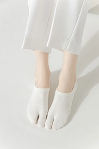 Close-up of white tabi split-toe invisible socks made of breathable cotton fabric