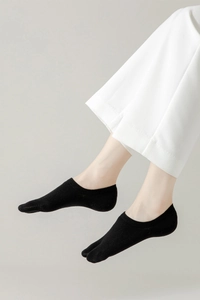Close-up of black cotton split-toe socks worn with shoes for tabi style and comfort