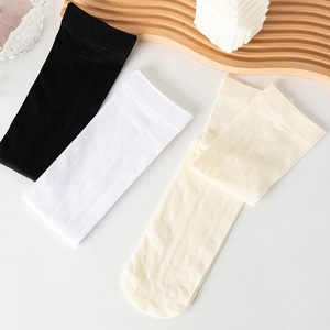 Three pairs of striped velvet calf socks in black, white, and beige on a wooden tray