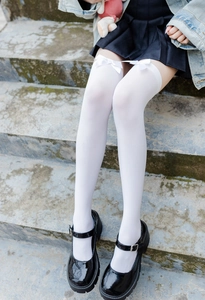 Close-up of white JK style over-the-knee socks with delicate bow ribbon details