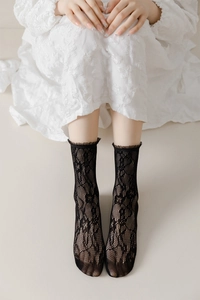 Detailed view of black lace mesh socks with ruffled trim for a stylish gothic JK style