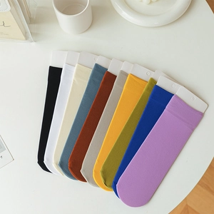 Detailed overhead view of ten pairs of colorful striped velvet mid-calf summer socks