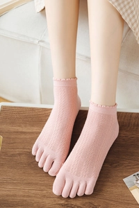 Close-up of pink five-finger socks featuring breathable hollow knit and ruffled lace cuffs