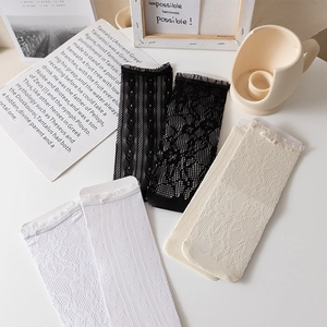 Lace white mesh socks with frilled edges displayed in an elegant flat lay set