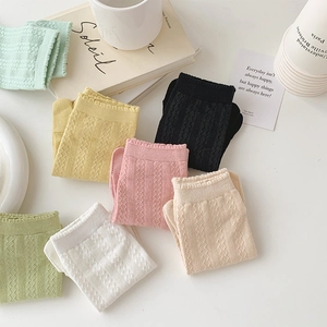 Flat lay of seven colorful hollow out cotton five-toe socks with diamond knit texture