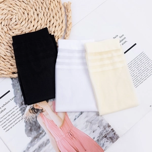 Three pairs of summer striped knee-high stockings in black, white, and beige colors