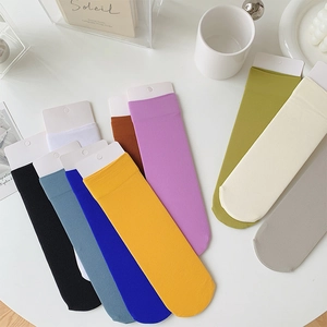 Detailed macro view of colorful ribbed crew socks with simple white paper display tags
