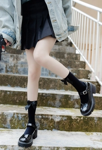 Detail of JK uniform black over-the-knee socks with cute bow and platform Mary Janes