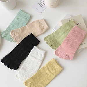 Flat lay of colorful five-finger socks in macaron tones with breathable mesh texture