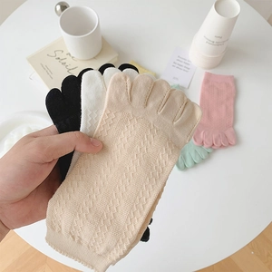 Close-up of mesh five-toe socks in various pastel colors with breathable knit texture