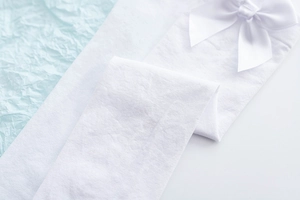 Detailed macro view of white JK style thigh high socks with elegant satin bow decor