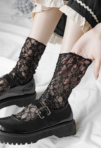 Detail of vintage black floral lace mesh socks paired with platform Mary Jane shoes