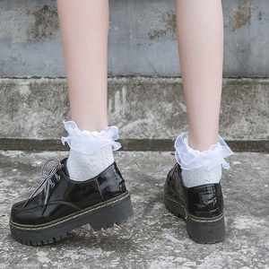 Lolita style black platform shoes with white lace heart cutout socks and yellow stitching