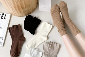 Detail of ribbed knit cotton socks in earth tones like cream and mocha with elastic cuffs
