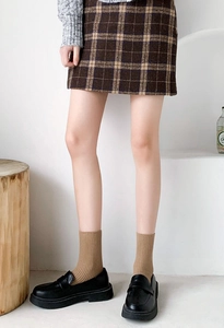 Classic brown plaid skirt paired with stylish brown mid-calf socks and black shoes