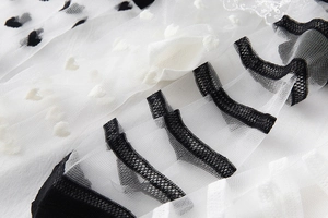 Vue macro de chaussettes en dentelle transparente avec pois, coeurs et rayures fines