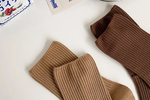 Detailed macro view of light and dark brown ribbed knit cotton crew socks texture